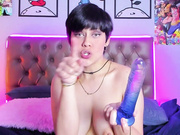 Teen girl with large breasts sucks on many toys