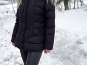 Sweet blond with black fur hooded jacket in snow forest