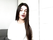 Sexy clothed brunette shows her legs in shiny pantyhose