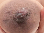 Zara_Lopez rests her tits on the table.