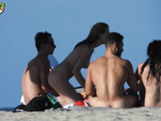 Pretty Woman Having Fun With Friends at Nudist Beach