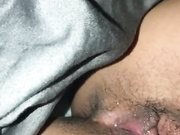 Cute teen fingering hairy pussy in bed