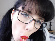 Brunette sucking lollipop