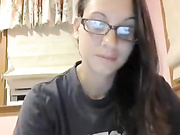 Nerdy girl with glasses strips on webcam