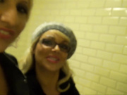 Lena and her friend in a public bathroom