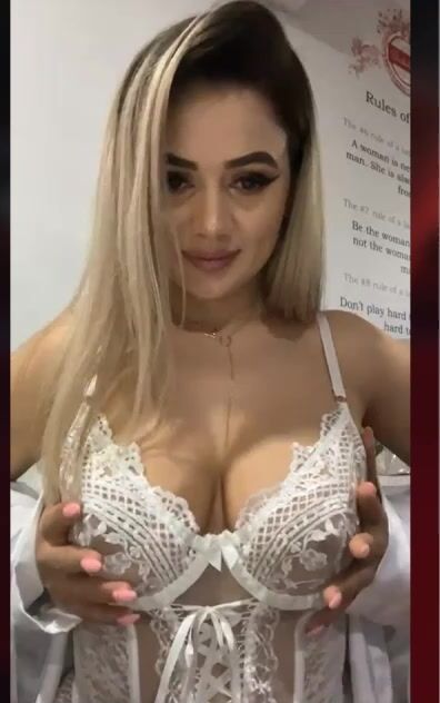 busty babe in white lace corset posing